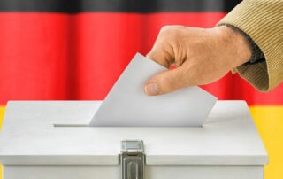 Man,Putting,A,Ballot,Into,A,Voting,Box,-,Germany