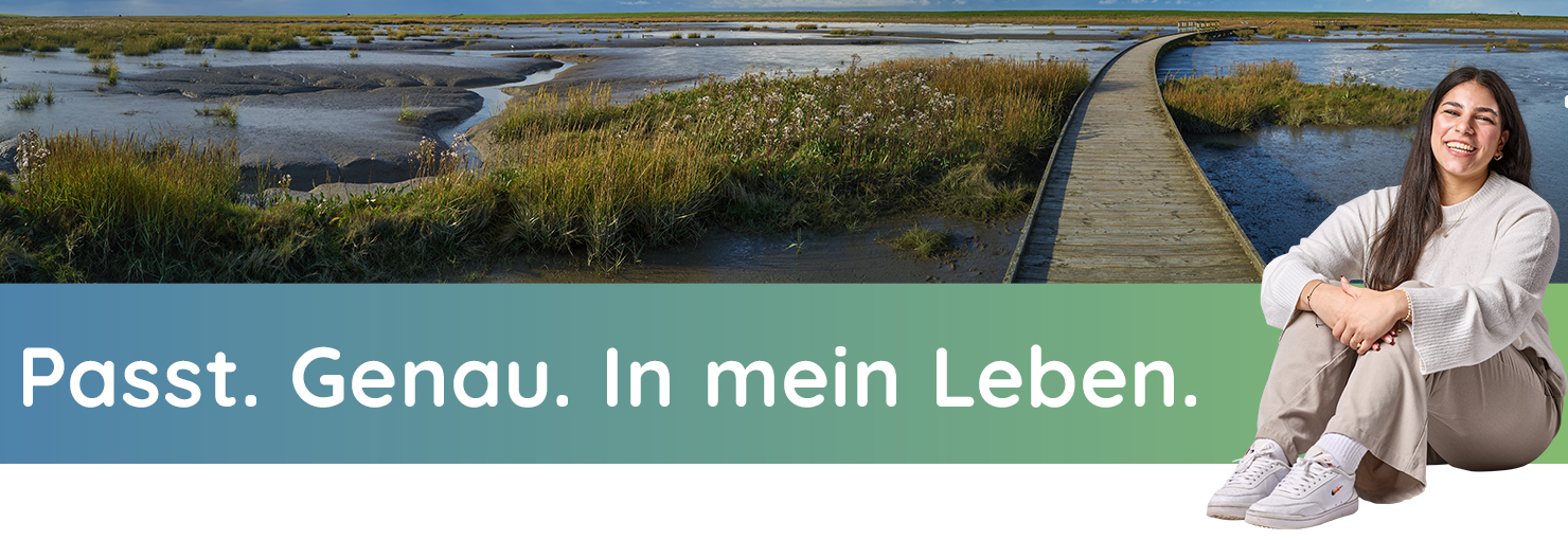 @Fraugesicht lächelt in Kamera. Dahinter steht eine Gruppe von vier Personen im Gespräch vertieft.